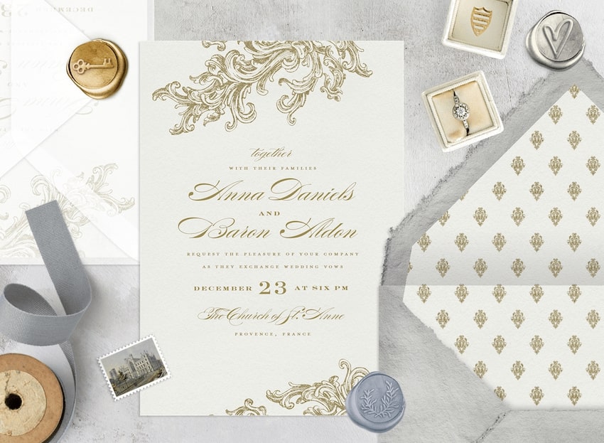 Formal wedding invitations, wax seals, and a wedding ring